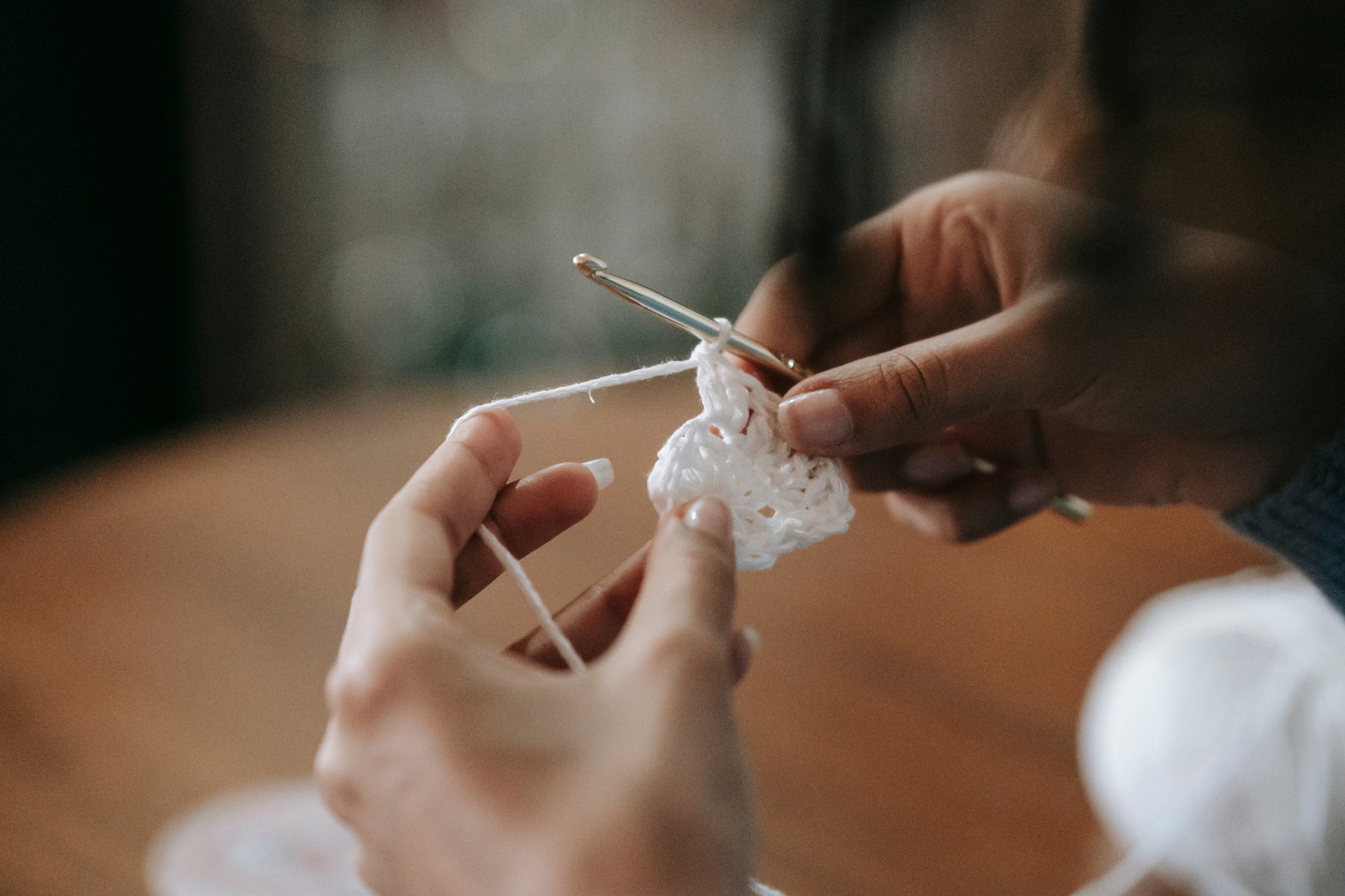 A Person Holding a Crochet Hook and Yarn